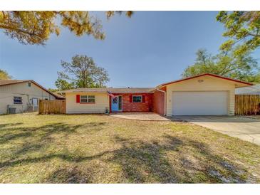 Charming one story home featuring an attached garage and a well maintained front yard at 2269 Beverly Ln, Clearwater, FL 33764