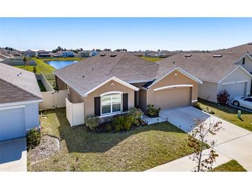 Charming single-story home with a well-manicured lawn and attached two car garage at 2812 Gumbo Limbo Dr, Wimauma, FL 33598