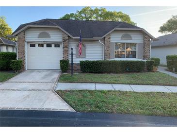 Charming single-story home featuring a well-maintained lawn and inviting curb appeal at 4740 Carrington Ct # 4740, New Port Richey, FL 34655