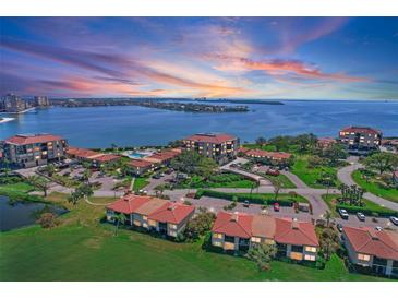 Stunning aerial view of the condo community with beautiful landscaping and water views during sunset at 6158 Palma Del Mar S Blvd # 406, St Petersburg, FL 33715