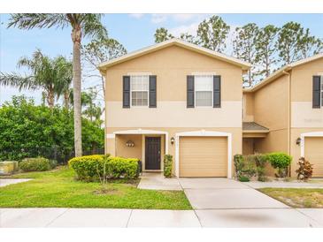 Charming two-story home with a well-maintained lawn and attached garage, perfect for comfortable living at 8012 Savannah Sunset Ln, Tampa, FL 33615