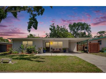 Charming single-story home with a well-maintained lawn, inviting curb appeal, and attached carport at 1623 San Mateo Dr, Dunedin, FL 34698