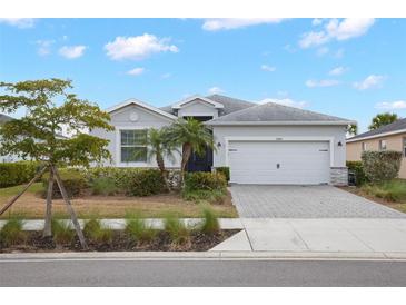Charming single-story home with well-manicured landscaping, paved driveway, and two-car garage at 17541 Timberline Pkwy, Punta Gorda, FL 33982