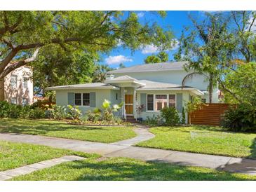 Charming home with beautifully landscaped front yard, walkway, and fresh exterior paint at 2217 Brevard Ne Rd, St Petersburg, FL 33704