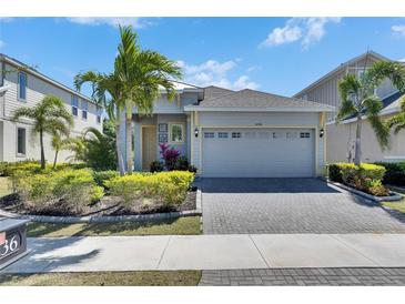 Well-maintained home exterior with lush landscaping, a paved driveway, and a two-car garage at 5236 Wishing Arch Dr, Apollo Beach, FL 33572