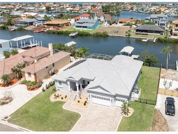 Stunning waterfront home featuring a spacious layout, a private boat dock, and lush landscaping at 819 Birdie Way, Apollo Beach, FL 33572