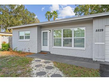 Charming single-story home showcasing updated textured paint, modern windows, and a welcoming entrance walkway at 8829 93Rd St, Seminole, FL 33777