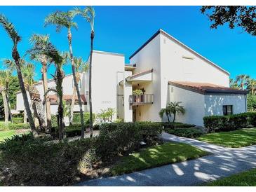 Beautiful two-story condo with a well-manicured lawn and mature tropical landscaping at 2055 Gulf Of Mexico Dr # G2-213, Longboat Key, FL 34228