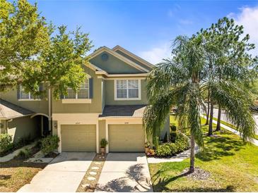 Inviting two-story home with a two-car garage and a beautifully landscaped front yard at 2759 Conch Hollow Dr, Brandon, FL 33511