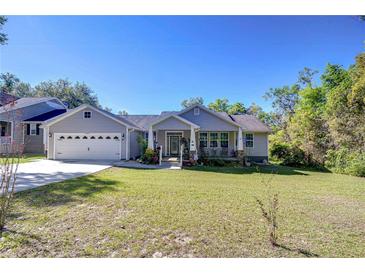 Charming home with a well-maintained lawn, attached garage and inviting front porch at 37362 Dixie Ave, Dade City, FL 33525