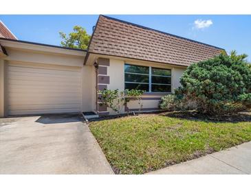 Charming home with a well-maintained lawn and tidy landscaping, enhancing its curb appeal at 8445 Calais N, Pinellas Park, FL 33781