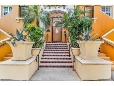 Stairway to building entrance with planters and orange walls at 100 4Th S Ave # 207, St Petersburg, FL 33701