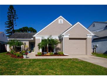 Charming single-story home with neutral paint, manicured landscaping, and a two-car garage at 12140 74Th St, Largo, FL 33773