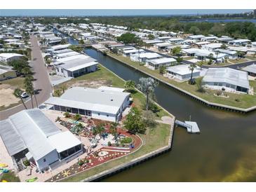 Waterfront property with canal access, landscaping, and outdoor decor in this charming residential community at 131 E Saint Annes Cir, Apollo Beach, FL 33572