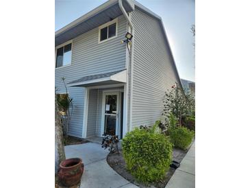 Charming two-story home showcasing new grey siding, manicured landscaping, and inviting entrance at 500 New York Ave # 21, Dunedin, FL 34698