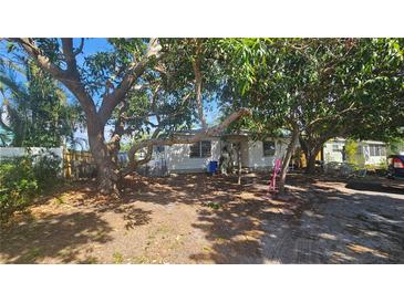 Charming single-story home with mature trees in the front yard providing lots of shade at 714 Gray S St, Gulfport, FL 33707