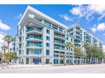 A modern condo building featuring stylish architecture, balconies, and lush landscaping at 111 N 12Th St # 1426, Tampa, FL 33602