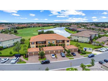 Beautiful condo community with lush landscaping, serene lake, and manicured golf course views at 13823 Messina Loop # 204, Bradenton, FL 34211