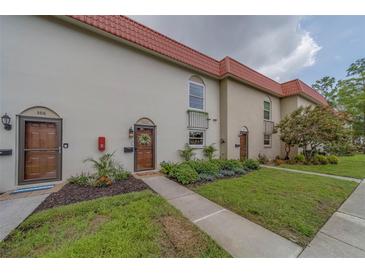 Charming townhome with red tile roof, updated landscaping, and decorative front door at 2700 Bayshore Blvd # 588, Dunedin, FL 34698
