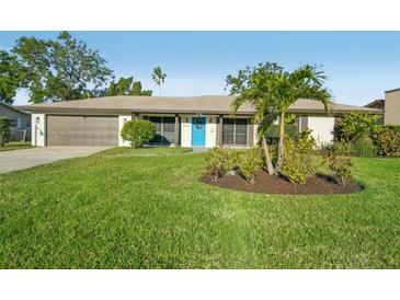 Charming single-story home with a well-manicured lawn and a bright blue front door at 4065 38Th S St, St Petersburg, FL 33711