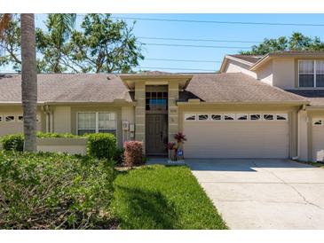 Charming home featuring a 2-car garage, neutral paint, and mature landscaping in a desirable neighborhood at 3056 Pepperwood W Ln, Clearwater, FL 33761