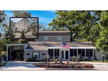 Charming single Gathering home with covered parking, well-manicured lawn and an American flag at 6166 9Th N Ave, St Petersburg, FL 33710