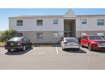 A two-story condo building with visitor parking and a tidy exterior at 7210 N Manhattan Ave # 1721, Tampa, FL 33614