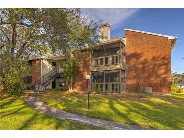 Charming two-story condo with brick facade, screened balconies, and lush landscaping at 9100 Dr Martin Luther King Jr N St # 1706, St Petersburg, FL 33702