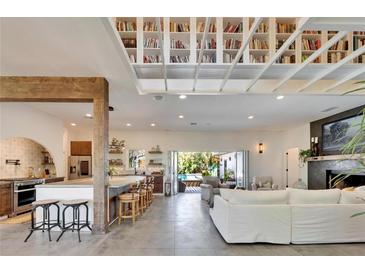 Bright living room with kitchen bar and a unique ceiling bookshelf design at 1715 Sunset Dr, Clearwater, FL 33755