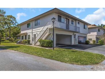 Two-story condo building featuring private balconies, covered parking, and well-manicured lawns at 1830 Bough Ave # 2, Clearwater, FL 33760