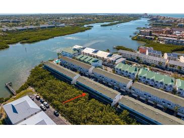 Aerial view of a waterfront condo community with lush green landscaping and beautiful water views at 19823 Gulf Blvd # 33, Indian Shores, FL 33785