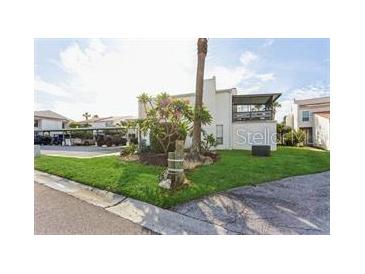 A two-story home with a lush green lawn and mature trees and the parking area at 4319 Harbor House Dr, Tampa, FL 33615