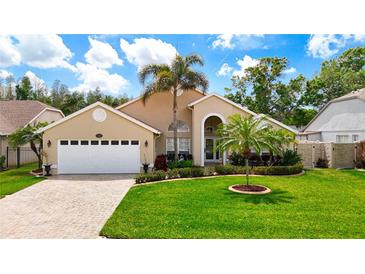 Charming single-story home with manicured lawn, lush landscaping, and inviting curb appeal at 6716 Frontier Ln, Tampa, FL 33625