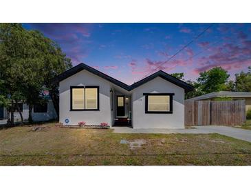Charming single-story home featuring a freshly painted white exterior, black trim, and a well-maintained front yard at 1138 Howard St, Clearwater, FL 33756