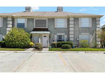 Charming townhome showcasing a well-maintained exterior and neatly landscaped front yard at 14019 Notreville Way, Tampa, FL 33624