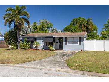 Charming single-story home with a well-manicured lawn, palm trees, and a concrete driveway leading to the entrance at 1541 68Th N Ave, St Petersburg, FL 33702