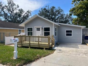 Charming single-story home showcasing a welcoming front porch and a well-maintained lawn at 1574 Ewing Ave, Clearwater, FL 33756