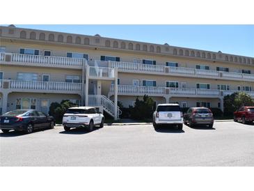 Attractive condo building featuring exterior stairs and ample parking at 2284 Philippine Dr # 41, Clearwater, FL 33763
