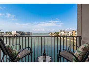 Balcony with two chairs has beautiful water views perfect for relaxing with a drink at 7300 Sun Island S Dr # 202, South Pasadena, FL 33707