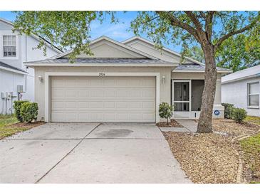 Charming single Gathering home with a two-car garage and a well maintained lawn at 7924 Carriage Pointe Dr, Gibsonton, FL 33534