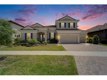 Charming two-story home with a well-manicured lawn, beautiful landscaping, and a three-car garage at 14239 Swiss Bridge Dr, Riverview, FL 33579