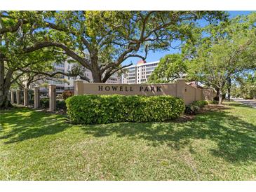 Howell Park signage with mature trees and lush landscaping against a blue sky backdrop at 2403 S Ardson Pl # 902B, Tampa, FL 33629