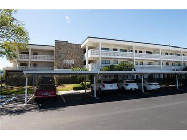 Exterior view of condo building, showing parking spaces and covered parking spots at 4910 Bay Ne St # 308, St Petersburg, FL 33703