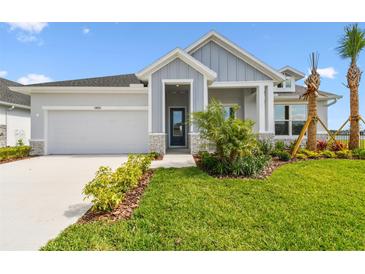 Charming single-Gathering home featuring a two-car garage, manicured lawn, and tasteful landscaping at 31651 Westbury Estates Ave, Wesley Chapel, FL 33545