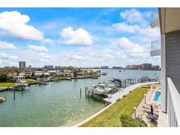 Beautiful waterfront view with boat docks and city skyline in the background at 610 Island Way # 302, Clearwater Beach, FL 33767