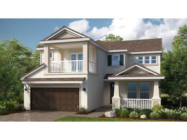 Two-story home featuring a balcony, a garage, beautiful landscaping, and a welcoming front porch at 1714 Trailhead Ln, Zephyrhills, FL 33541