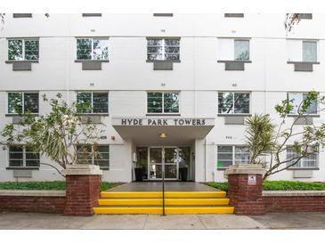 Exterior view of Hyde Park Towers, featuring yellow stairs leading to the entrance at 406 W Cedar St # 403, Tampa, FL 33606