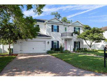 Charming two-story home featuring a two-car garage, a balcony, and a well-maintained brick driveway at 4105 W Corona St, Tampa, FL 33629