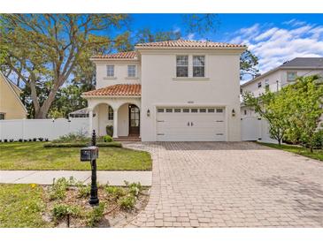 Stunning two-story home with red tile roof, well-manicured lawn, and brick driveway at 4310 W Sevilla St, Tampa, FL 33629