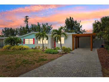 Charming home with manicured lawn, stone driveway, mature landscaping and covered parking at 438 62Nd St, Holmes Beach, FL 34217